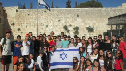 A group of campers holding the Israeli flag.