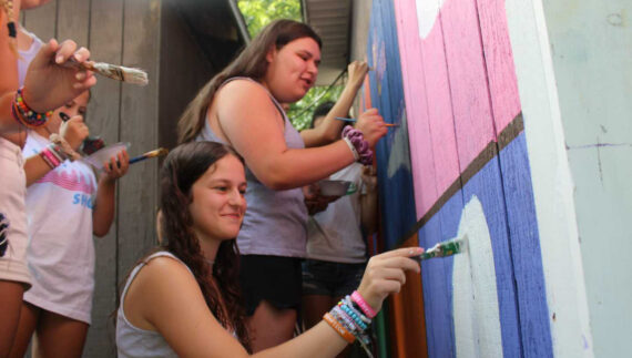 Campers painting a mural.
